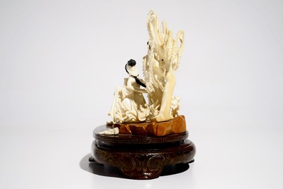 A Chinese carved ivory group of two ladies on wooden base, 2nd quarter 20th C.
