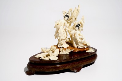 A Chinese carved ivory group of two ladies on wooden base, 2nd quarter 20th C.