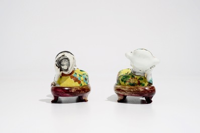 A pair of Chinese famille rose wall pocket vases shaped as resting figures, early 19th C.