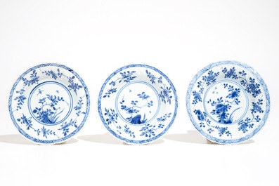 Three Chinese blue and white and caf&eacute; au lait-glazed cups and saucers, Kangxi