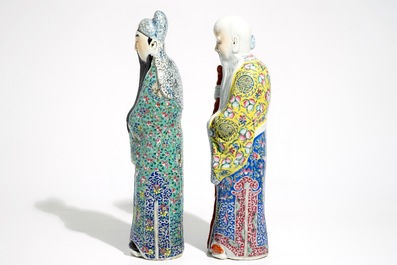A pair of Chinese famille rose figures of immortals on wooden bases, 19/20th C.