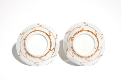 A pair of Chinese cups and saucers with gilt design, Yongzheng/Qianlong