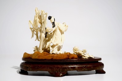 A Chinese carved ivory group of two ladies on wooden base, 2nd quarter 20th C.