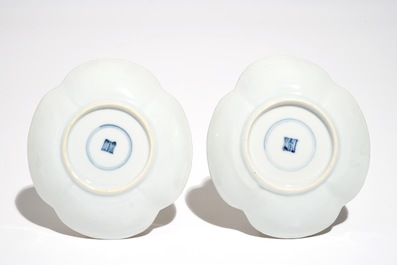 A pair of Chinese milk and blood quatrefoil cups and saucers, Kangxi