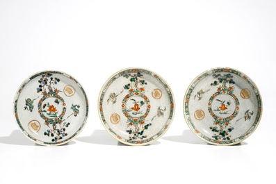 Three Chinese famille verte crackle glaze cups and saucers and a blue and white soft paste bowl, Kangxi