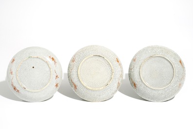Three Chinese famille verte crackle glaze cups and saucers and a blue and white soft paste bowl, Kangxi