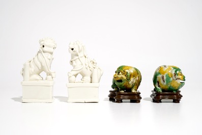 A pair of Chinese Dehua blanc de Chine Buddhist lion joss stick holders and a pair of verte biscuit dogs, Kangxi
