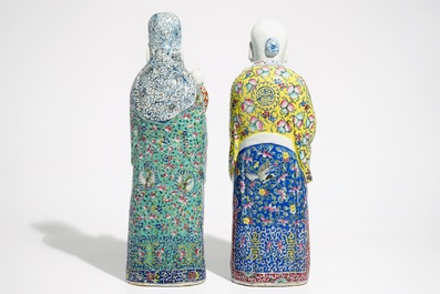 A pair of Chinese famille rose figures of immortals on wooden bases, 19/20th C.