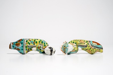 A pair of Chinese famille rose wall pocket vases shaped as resting figures, early 19th C.
