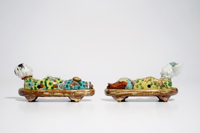 A pair of Chinese famille rose wall pocket vases shaped as resting figures, early 19th C.