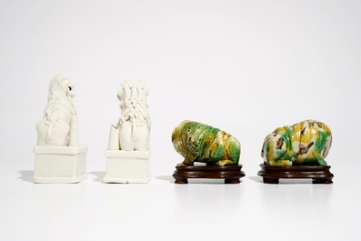 A pair of Chinese Dehua blanc de Chine Buddhist lion joss stick holders and a pair of verte biscuit dogs, Kangxi