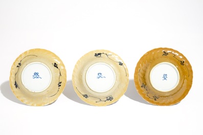 Three Chinese blue and white and caf&eacute; au lait-glazed cups and saucers, Kangxi