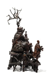 A large Chinese carved root wood group with a Luohan, 19th C.