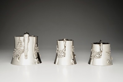 A Chinese silver teapot, milk jug and sugar bowl, Luen Wo, 1880-1940