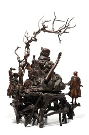 A large Chinese carved root wood group with a Luohan, 19th C.