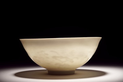 A Chinese monochrome white eggshell anhua bowl with applied design, Yongzheng mark, 19/20th C.