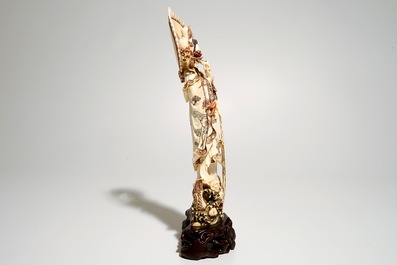 A Japanese ivory model of Guanyin on a carp, Taisho, ca. 1930, signed