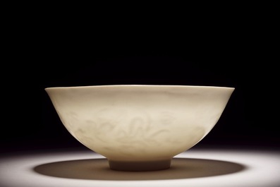 A Chinese monochrome white eggshell anhua bowl with applied design, Yongzheng mark, 19/20th C.
