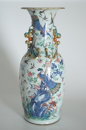 A very large Chinese famille rose vase with a peacock, 19th C.
