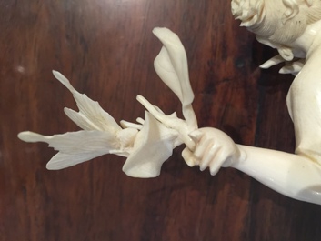 A Chinese ivory figure of a lady with a butterfly, early 20th C.