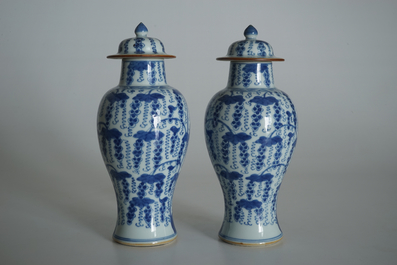 A pair of Chinese blue and white vases and covers with grapes, Kangxi