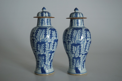 A pair of Chinese blue and white vases and covers with grapes, Kangxi