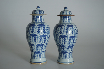 A pair of Chinese blue and white vases and covers with grapes, Kangxi