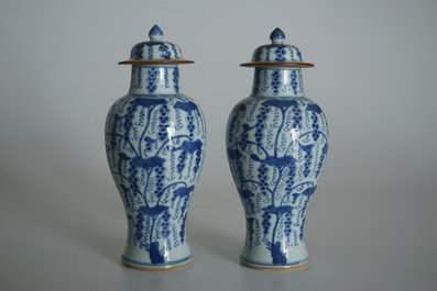 A pair of Chinese blue and white vases and covers with grapes, Kangxi