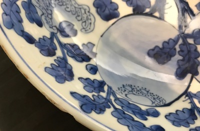 A Chinese blue and white dish with sanduo fruits among foliage, Kangxi