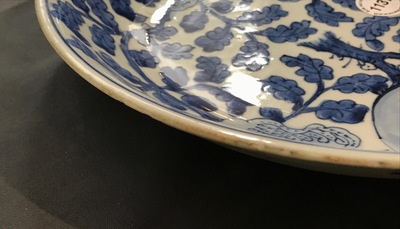 A Chinese blue and white dish with sanduo fruits among foliage, Kangxi
