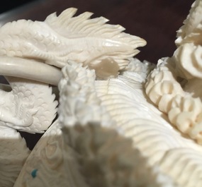 A Chinese encrusted ivory vase on wooden stand, early 20th C.