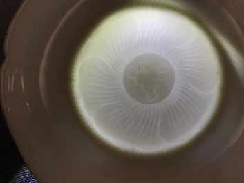 Three blanc de Chine cups and saucers with floral anhua design, Yongzheng/Qianlong