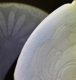 A Chinese incised qingbai foliate bowl with underglaze floral design, Song