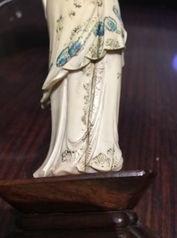 A Chinese polychrome ivory figure on wooden stand, 2nd quarter 20th C.