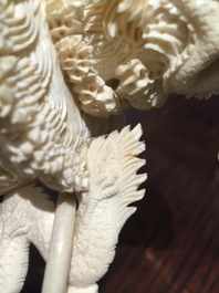 A Chinese encrusted ivory vase on wooden stand, early 20th C.