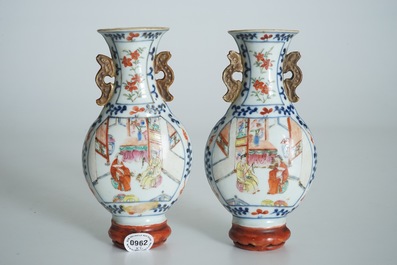 A pair of Chinese famille rose wall vases with figural design, 19th C.