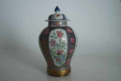 A Chinese bronze-mounted famille rose on blue-ground baluster vase and cover, Yongzheng