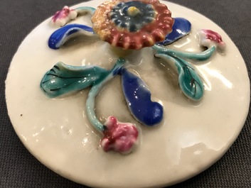 A Chinese famille rose teapot on stand with applied decoration, Yonzheng