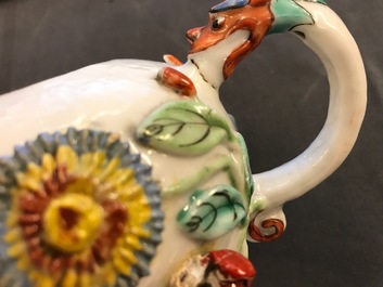A Chinese famille rose teapot on stand with applied decoration, Yonzheng