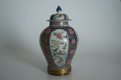 A Chinese bronze-mounted famille rose on blue-ground baluster vase and cover, Yongzheng
