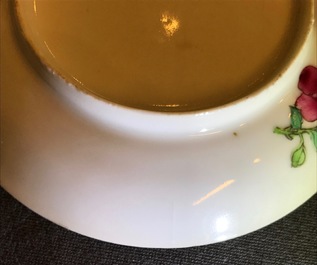 A Chinese famille rose cup and saucer with an insect on sanduo fruit, Yongzheng