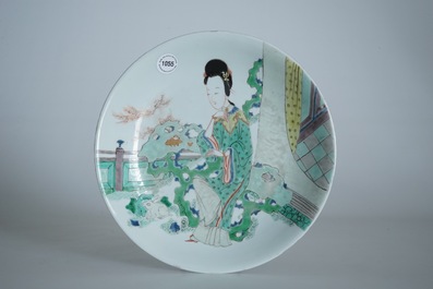 A Chinese famille verte plate with a lady in the garden, Kangxi mark and period