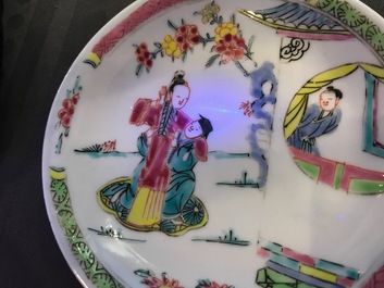 A Chinese famille rose cup and saucer with figures in a garden, Yongzheng
