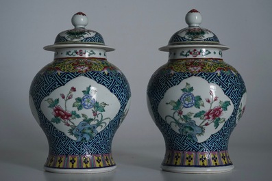 A pair of Chinese famille rose vases and covers, 19th C., and a pair of blue and white dishes, 20th C.