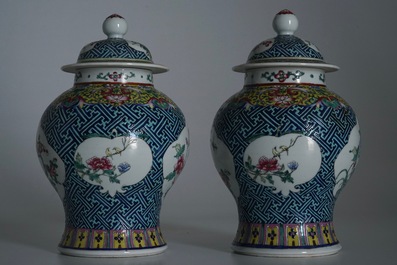 A pair of Chinese famille rose vases and covers, 19th C., and a pair of blue and white dishes, 20th C.