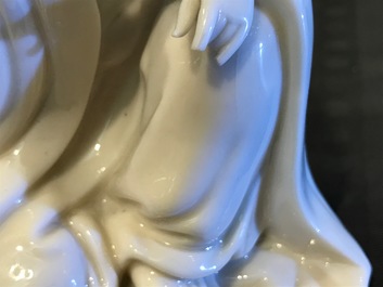 A Chinese Dehua blanc de Chine Guanyin on wooden stand, Kangxi