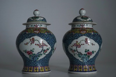 A pair of Chinese famille rose vases and covers, 19th C., and a pair of blue and white dishes, 20th C.