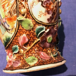 A pair of Chinese famille rose relief-decorated mandarin vases, Qianlong