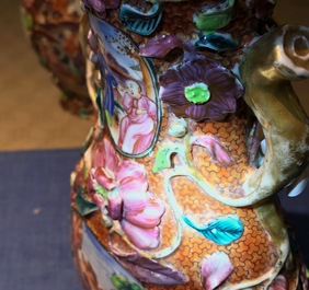 A pair of Chinese famille rose relief-decorated mandarin vases, Qianlong