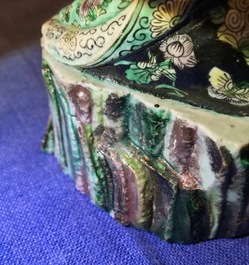 Een Chinese verte biscuit figuur van een luohan met schriftrol, Kangxi